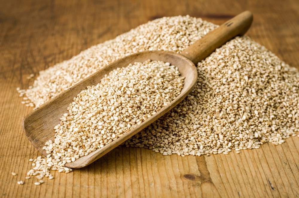 Wooden scoop with sesame seeds